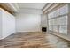 Spacious living room with fireplace, wood floors, and large bright windows at 5203 Coffeeberry Ln, Charlotte, NC 28227