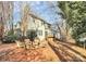 Backyard showcasing a cozy fire pit area with seating, set against the home's exterior and mature trees at 5323 Dewmorn Pl, Charlotte, NC 28269