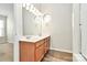 Bathroom features a double sink vanity with wood cabinets, two mirrors, and a shower at 5323 Dewmorn Pl, Charlotte, NC 28269
