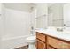 Clean bathroom with a shower-tub combo, wooden vanity, and a large mirror, providing ample space at 5323 Dewmorn Pl, Charlotte, NC 28269