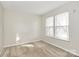 Bright bedroom filled with natural light from the windows; neutral carpet and paint create a warm, inviting atmosphere at 5323 Dewmorn Pl, Charlotte, NC 28269
