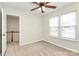Bedroom with open doorway and a staircase in view; lots of natural light for a bright and welcoming space at 5323 Dewmorn Pl, Charlotte, NC 28269