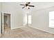 Second bedroom features carpet, neutral walls, a window, and a ceiling fan at 5323 Dewmorn Pl, Charlotte, NC 28269