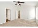 Third bedroom with carpet, neutral walls, a window, and a ceiling fan at 5323 Dewmorn Pl, Charlotte, NC 28269