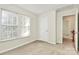 Neutral bedroom with carpet and natural light; a closed closet and open hallway add depth to the living space at 5323 Dewmorn Pl, Charlotte, NC 28269