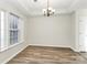 The light-filled dining area features wood floors and neutral paint, creating an inviting atmosphere at 5323 Dewmorn Pl, Charlotte, NC 28269
