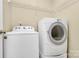 Functional laundry area features a Whirlpool washer and dryer set with built-in shelving for optimal storage at 5323 Dewmorn Pl, Charlotte, NC 28269