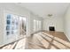 The spacious living room features wood flooring, a fireplace, and sliding doors to the backyard at 5323 Dewmorn Pl, Charlotte, NC 28269