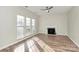 The spacious living room features wood flooring, a fireplace, and natural light through the large windows at 5323 Dewmorn Pl, Charlotte, NC 28269