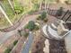 Landscaped backyard featuring stone steps, gravel paths, mature trees, and a wrought iron fence at 720 9Th Nw Ave, Hickory, NC 28601