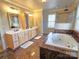 Luxurious bathroom with a soaking tub, separate shower, double vanity, and marble countertops at 720 9Th Nw Ave, Hickory, NC 28601