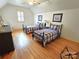 Bedroom featuring two twin beds with matching decor, hardwood floors, and a ceiling fan at 720 9Th Nw Ave, Hickory, NC 28601