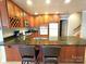 Kitchen featuring wood cabinets, granite countertop island with seating, and stainless steel appliances at 720 9Th Nw Ave, Hickory, NC 28601