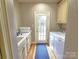 Functional laundry room with washer, dryer, sink, counter space, and storage cabinets at 720 9Th Nw Ave, Hickory, NC 28601