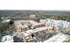 An aerial showcases complex buildings, inner courtyard pool, parking lots and city skyline in distance at 720 Governor Morrison St # 207, Charlotte, NC 28211