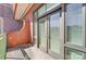 Balcony with sliding glass doors, a brick wall, and a green railing for privacy and enjoying the outdoors at 720 Governor Morrison St # 207, Charlotte, NC 28211