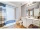 Bathroom featuring a shower-tub combo, toilet, and vanity with modern fixtures at 720 Governor Morrison St # 207, Charlotte, NC 28211