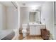 Bright bathroom featuring a shower-tub combo, toilet, and vanity with white cabinetry at 720 Governor Morrison St # 207, Charlotte, NC 28211