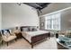 Serene bedroom with ample natural light, ceiling fan, and a comfortable seating area at 720 Governor Morrison St # 207, Charlotte, NC 28211