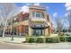 Striking red brick exterior building with a canopy, balcony, and manicured shrubs at 720 Governor Morrison St # 207, Charlotte, NC 28211