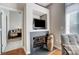 Cozy fireplace in living room with built-in TV niche, flanked by large decorative urns at 720 Governor Morrison St # 207, Charlotte, NC 28211