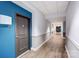 Bright hallway with light wood floors, two-tone paint, and apartment doors at 720 Governor Morrison St # 207, Charlotte, NC 28211