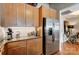 Kitchen with stainless steel refrigerator and wood cabinets offering ample storage and counter space at 720 Governor Morrison St # 207, Charlotte, NC 28211