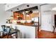 Open kitchen with wood cabinets, granite counters, and stainless steel appliances at 720 Governor Morrison St # 207, Charlotte, NC 28211