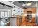 Modern kitchen with stainless appliances, wood cabinets, and stylish lighting with open floor plan at 720 Governor Morrison St # 207, Charlotte, NC 28211
