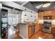 Contemporary kitchen featuring stainless steel appliances, wood cabinets, and an open view to living area at 720 Governor Morrison St # 207, Charlotte, NC 28211