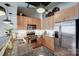 Kitchen with stainless steel appliances, wood cabinets, and granite countertops at 720 Governor Morrison St # 207, Charlotte, NC 28211