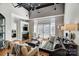 Bright living room with fireplace, hardwood floors, ceiling fan and french doors leading to balcony at 720 Governor Morrison St # 207, Charlotte, NC 28211