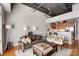 Open concept living area with hardwood floors, modern furnishings, ceiling fan and partial kitchen view at 720 Governor Morrison St # 207, Charlotte, NC 28211