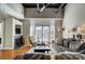 Bright living room with fireplace, hardwood floors, ceiling fan and french doors leading to balcony at 720 Governor Morrison St # 207, Charlotte, NC 28211