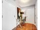 Hallway office featuring a glass desk with a modern lamp and decor at 720 Governor Morrison St # 207, Charlotte, NC 28211