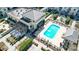Aerial view of a pool with lounge chairs, greenery, and a covered outdoor seating area at 720 Governor Morrison St # 207, Charlotte, NC 28211