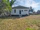The backyard offers a spacious grassy area and a view of the home's exterior, complete with a classic black door at 720 Holmes St, Salisbury, NC 28144