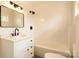Bathroom featuring a vanity with a black faucet and a subway-tiled shower/tub combo at 720 Holmes St, Salisbury, NC 28144