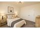 Cozy bedroom with neutral tones, bedside tables, lamps, and soft carpet flooring at 720 Holmes St, Salisbury, NC 28144