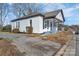 Charming home featuring white siding, a covered front porch, and an inviting, well-maintained lawn at 720 Holmes St, Salisbury, NC 28144