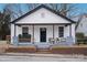 Charming home featuring a welcoming front porch with seating and landscaped accents at 720 Holmes St, Salisbury, NC 28144
