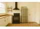 Modern kitchen with stainless steel appliances, butcher block countertops, and white cabinetry at 720 Holmes St, Salisbury, NC 28144