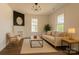 Bright living room with fireplace, modern lighting, neutral decor, and wood flooring at 720 Holmes St, Salisbury, NC 28144