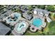 Overhead view of community amenities including a clubhouse, pools, and water park, all surrounded by lush greenery at 805 Deep River Way, Waxhaw, NC 28173