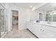 Spacious bathroom with double vanity, drawers and cabinet, walk-in shower, and an adjoining walk-in closet at 805 Deep River Way, Waxhaw, NC 28173