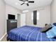 Bedroom featuring modern decor, a large window, and a wall-mounted TV at 805 Deep River Way, Waxhaw, NC 28173