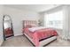 Charming bedroom with a cozy pink bed, plush bedding, and a bright window at 805 Deep River Way, Waxhaw, NC 28173