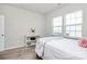 Bright bedroom with two windows, plush carpet, neutral walls and a bed with a white and floral comforter at 805 Deep River Way, Waxhaw, NC 28173