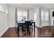 Cozy dining area with a table set for four, surrounded by natural light from the windows at 805 Deep River Way, Waxhaw, NC 28173