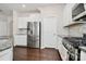 Well-equipped kitchen with stainless steel appliances, white cabinetry, and a gas range at 805 Deep River Way, Waxhaw, NC 28173